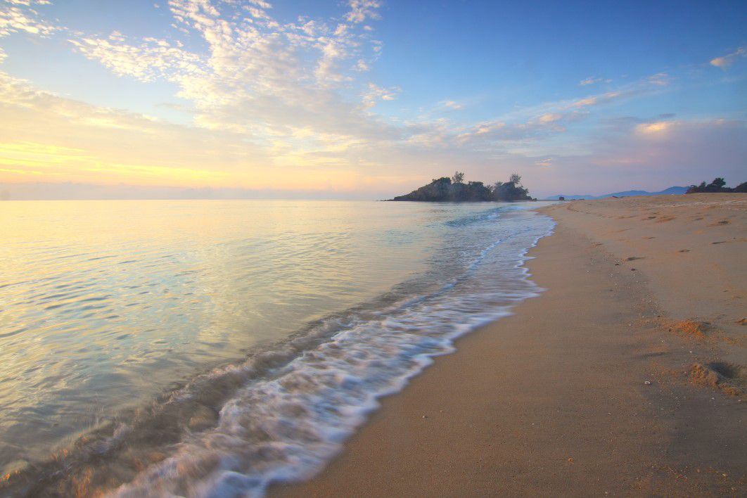 a calm beach at sunrise